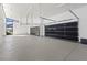 Bright, oversized garage with high ceilings and reflective glass doors at 1 Olympia Canyon Way, Las Vegas, NV 89141