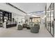 Open-concept living area featuring soaring ceilings, large windows, and a seamless flow into dining and kitchen at 1 Olympia Canyon Way, Las Vegas, NV 89141