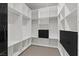 Modern walk-in closet features custom white shelving with black drawers, offering ample storage space and organization at 1 Olympia Canyon Way, Las Vegas, NV 89141