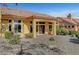 Back exterior of the house with a patio, desert landscaping, and rock garden at 9833 Villa Ridge Dr, Las Vegas, NV 89134