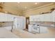 Spacious kitchen with white cabinets and appliances at 9833 Villa Ridge Dr, Las Vegas, NV 89134