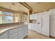 Modern kitchen with white cabinets, large island, and views from the window at 9833 Villa Ridge Dr, Las Vegas, NV 89134