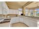 Spacious kitchen featuring white cabinets, breakfast bar, and large windows at 9833 Villa Ridge Dr, Las Vegas, NV 89134