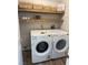 Functional laundry room featuring modern washer and dryer, complemented by stylish shelves for storage at 7813 Paper Flower Ct, Las Vegas, NV 89128