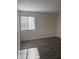 Bedroom with a large window bringing in natural light and wood-look flooring at 5317 Indian River Dr # 295, Las Vegas, NV 89103