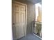 View of the front door, a balcony with railings, and stucco walls at 5317 Indian River Dr # 295, Las Vegas, NV 89103