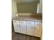 Close up of lower cabinets and breakfast bar area with gray countertops at 5317 Indian River Dr # 295, Las Vegas, NV 89103