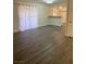 Spacious living room featuring gray wood-look flooring and a large sliding glass door at 5317 Indian River Dr # 295, Las Vegas, NV 89103