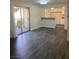 Open-concept living room with hardwood floors and a view to the kitchen and balcony at 5317 Indian River Dr # 295, Las Vegas, NV 89103