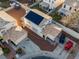 Aerial view of a two-story home featuring solar panels, tile roof, desert landscaping, and multi-car driveway at 2801 Willow Wind Ct, Las Vegas, NV 89117