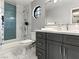 Bathroom with gray vanity, blue tile, and walk-in shower at 2801 Willow Wind Ct, Las Vegas, NV 89117