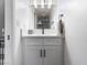 Updated bathroom with white vanity, hexagon tile, and modern fixtures at 2801 Willow Wind Ct, Las Vegas, NV 89117