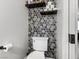 Small bathroom with hexagon tile and floating shelves at 2801 Willow Wind Ct, Las Vegas, NV 89117