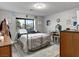 Cozy bedroom with a metal frame bed, plush bedding, neutral-colored walls, and wood-look floors at 2801 Willow Wind Ct, Las Vegas, NV 89117