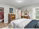 Bedroom with a metal frame bed, plush bedding, neutral-colored walls, wood-look floors, and attached bath at 2801 Willow Wind Ct, Las Vegas, NV 89117