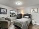 Bedroom with gray upholstered bed, wood-look floors, and window at 2801 Willow Wind Ct, Las Vegas, NV 89117