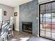 Living room with stone fireplace and sliding glass door to backyard at 2801 Willow Wind Ct, Las Vegas, NV 89117
