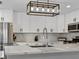 Modern kitchen features white cabinets, quartz countertops, and stainless steel appliances at 2801 Willow Wind Ct, Las Vegas, NV 89117