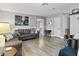 Spacious living room with gray sofas, wood-look floors, and large artwork at 2801 Willow Wind Ct, Las Vegas, NV 89117
