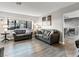 Living room with gray sofas, wood-look floors, and view into dining area at 2801 Willow Wind Ct, Las Vegas, NV 89117