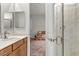 View of the bathroom with a sink, shower, and a glimpse into an adjacent bedroom at 44 Strada Caruso, Henderson, NV 89011