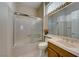 Bright bathroom featuring a tub/shower combination with sliding glass doors at 1950 Colvin Run Dr, Henderson, NV 89052