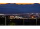 A captivating evening view showcasing the city skyline and surrounding mountains at 1950 Colvin Run Dr, Henderson, NV 89052