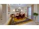 Formal dining room with chandelier, mirror accent wall, and elegant furnishings at 1950 Colvin Run Dr, Henderson, NV 89052