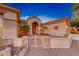 Inviting front entrance featuring desert landscaping and gated front courtyard with palms at 1950 Colvin Run Dr, Henderson, NV 89052