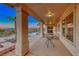 Covered patio with view of the pool, palm trees, and mountains beyond at 1950 Colvin Run Dr, Henderson, NV 89052