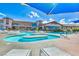 Inviting community pool with in-water islands, lounge chairs, and a clear blue sky creating a relaxing oasis at 1950 Colvin Run Dr, Henderson, NV 89052