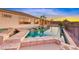 Luxurious backyard pool with a swim-up bar and mountain views in the background at 1950 Colvin Run Dr, Henderson, NV 89052