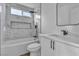 Modern bathroom with marble tile, updated black hardware, and a shower/tub combo at 2606 Vegas Valley Dr, Las Vegas, NV 89121