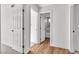 Bright hallway with white doors and neutral walls, leading to a bathroom with tiled shower at 2606 Vegas Valley Dr, Las Vegas, NV 89121