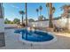 Sparkling in-ground pool surrounded by mature palm trees and lush landscaping, creating a private backyard escape at 2606 Vegas Valley Dr, Las Vegas, NV 89121