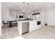 Spacious kitchen and dining area with stainless steel appliances, white cabinetry, and an open floor plan at 10631 Sariah Skye Ave, Las Vegas, NV 89166