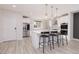 Well-lit kitchen with white cabinets, stainless steel appliances, a large island, and sleek countertops at 10631 Sariah Skye Ave, Las Vegas, NV 89166