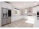 Contemporary kitchen with stainless steel refrigerator, white cabinets, ample countertop space, and modern appliances at 10631 Sariah Skye Ave, Las Vegas, NV 89166