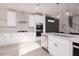 Modern kitchen design showcasing stainless steel appliances, white cabinetry, and a stylish island with pendant lighting at 10631 Sariah Skye Ave, Las Vegas, NV 89166