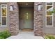 Contemporary home featuring a modern front door framed by stone pillars and manicured landscaping at 11280 Granite Ridge Dr # 1075, Las Vegas, NV 89135