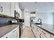 Modern kitchen with white cabinets and dark herringbone backsplash at 2667 Kindswood St, Henderson, NV 89044