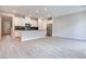 Open concept kitchen with white cabinets and island at 2667 Kindswood St, Henderson, NV 89044