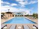 Relaxing community pool featuring lounge chairs and a modern building in the background at 2667 Kindswood St, Henderson, NV 89044