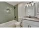 Updated bathroom with a green tile shower and modern vanity at 512 Purcell Dr, Las Vegas, NV 89107