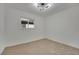 Well-lit bedroom featuring neutral carpeting and a window at 512 Purcell Dr, Las Vegas, NV 89107