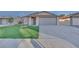 One-story house with artificial turf lawn and attached two-car garage at 512 Purcell Dr, Las Vegas, NV 89107