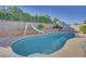 Inviting kidney-shaped pool with a slide in the backyard at 512 Purcell Dr, Las Vegas, NV 89107