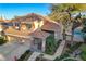 Two-story house with a pool and lush landscaping in a residential neighborhood at 1833 Indian Bend, Henderson, NV 89074