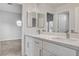 Double vanity bathroom with white cabinets and quartz countertops at 1833 Indian Bend, Henderson, NV 89074