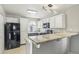 Modern kitchen with granite countertops and black appliances at 3125 N Buffalo Dr # 1133, Las Vegas, NV 89128